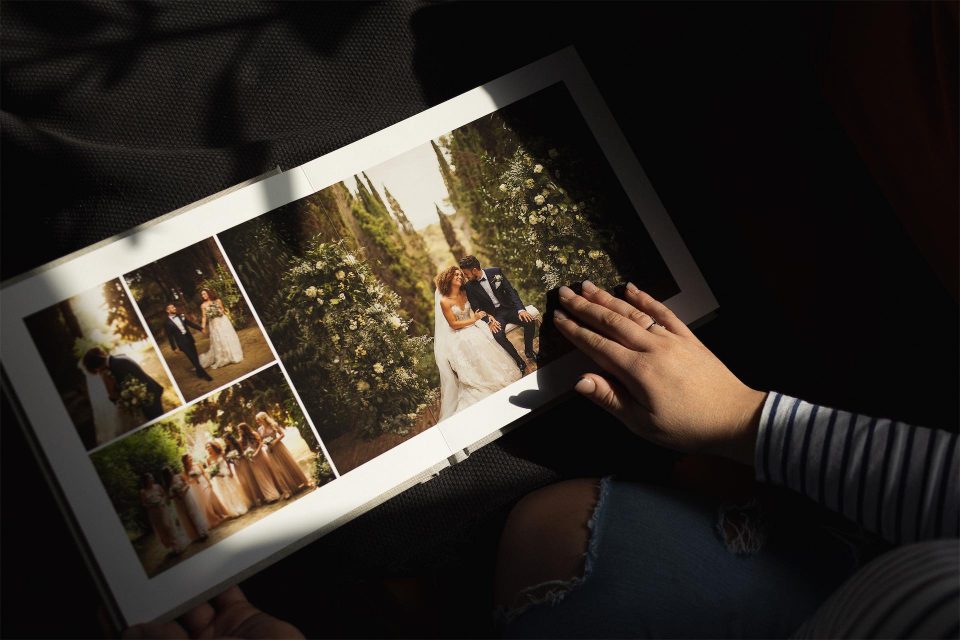 Dark and moody photo of a Folio fine art photo book with wedding images inside