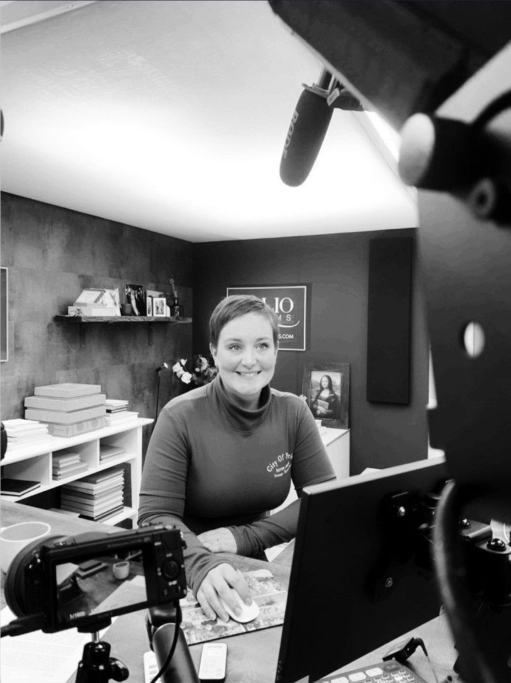 A black and white photo showing one of the Folio Albums team helping a photographer via a Zoom call.