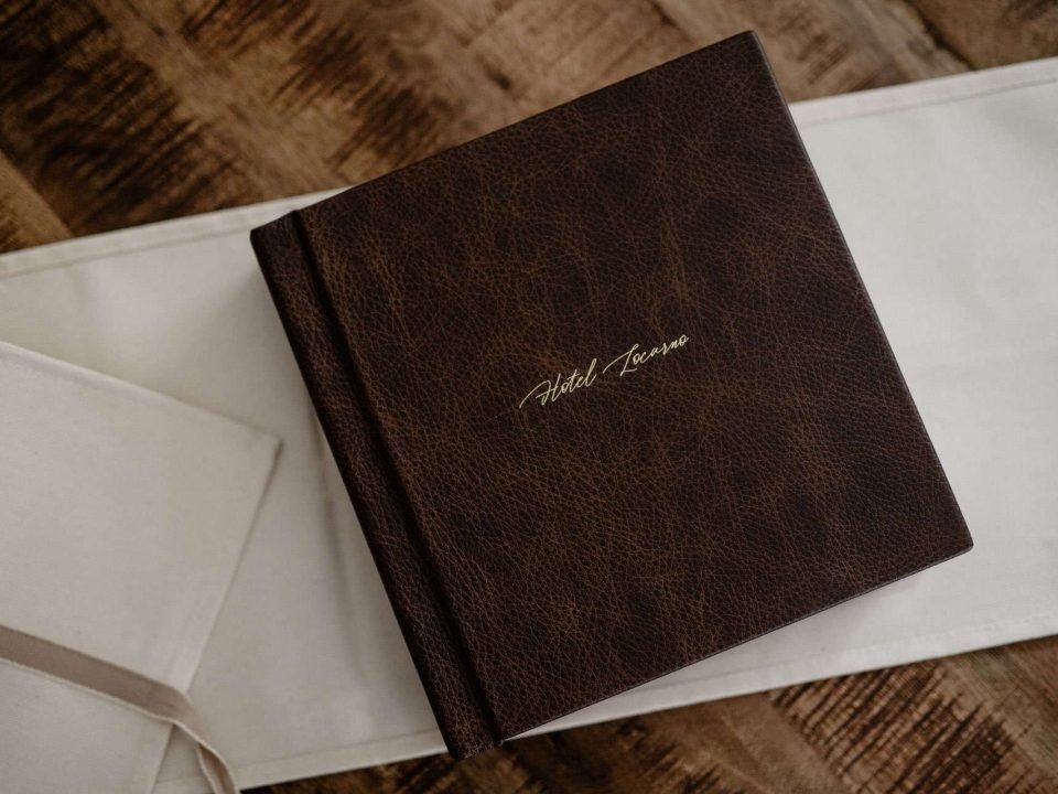 A brown vintage leather 8x8 matted album on a natural cotton wrap