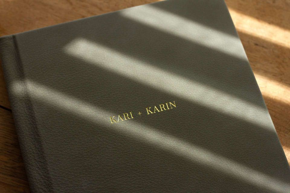A suede leather bound album with gold foiled personalised cover text