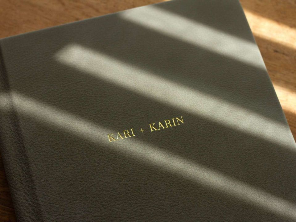 A suede leather bound album with gold foiled personalised cover text