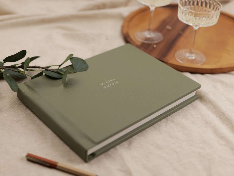 A landscape A4 sized leather bound guest book in a sage colour
