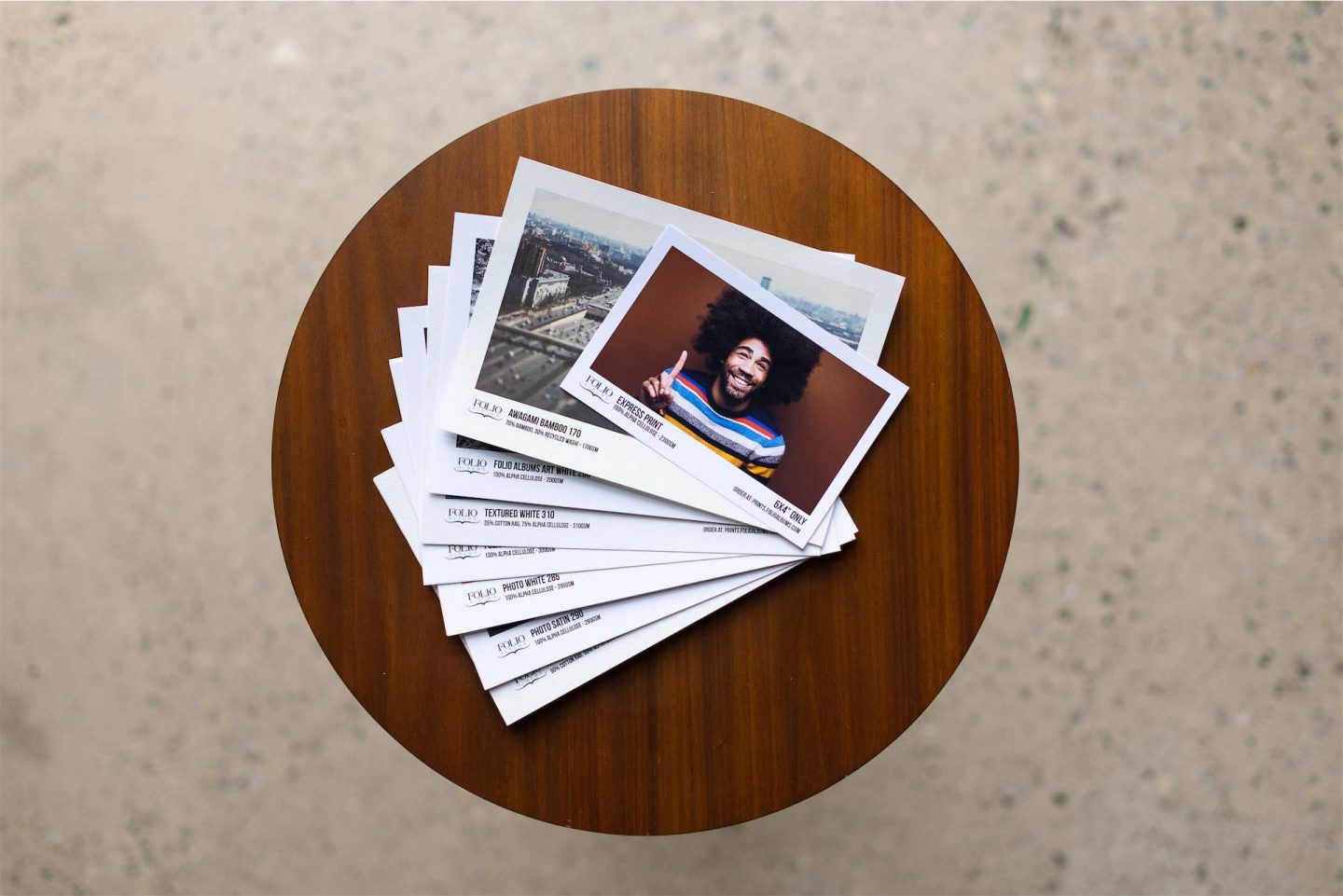 A stack of photos on a table printed on the different paper types available