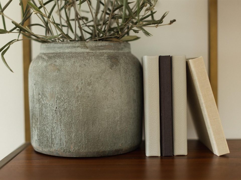 A closer image showing a collection of fabric and leather square mini albums on a shelf