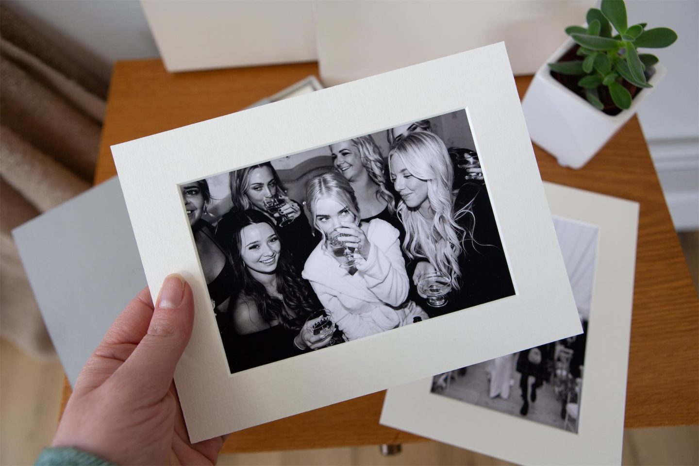 A bride holding a matted print that is included in the Thank You Box from her photographer. Featuring a way to send gallery previews.