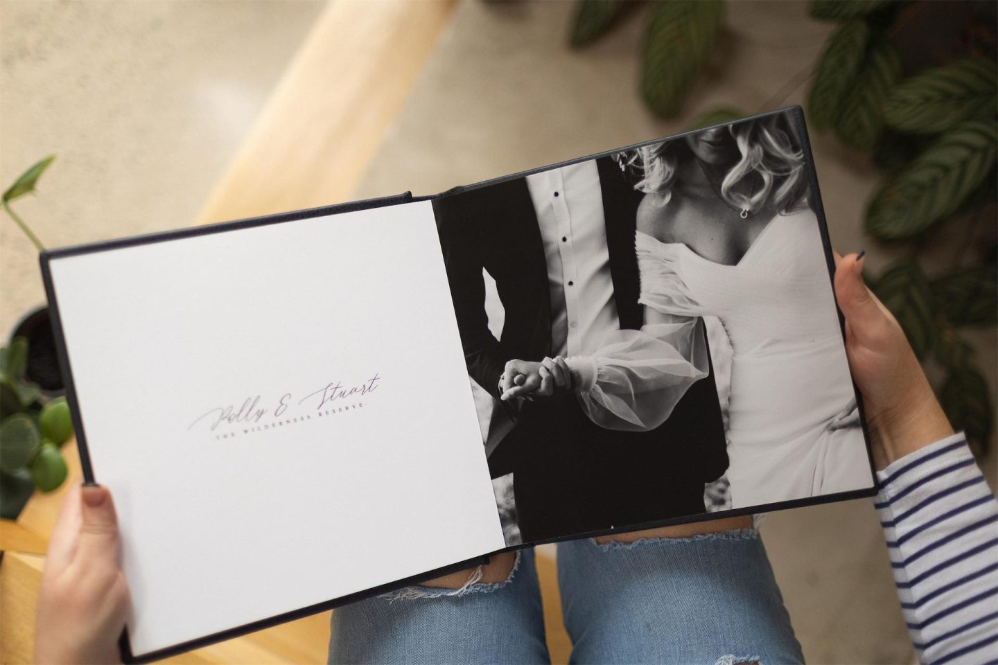 Opened wedding album showing the first spread with a title and couple shot