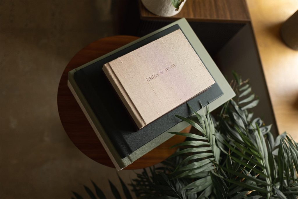 A silk covered landscape photo book with names imprinted on the front cover