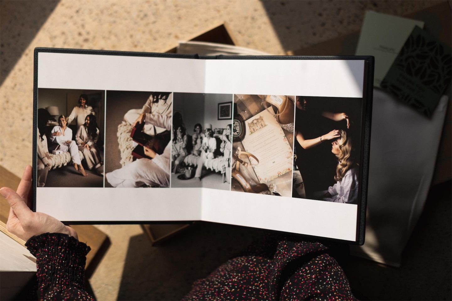 An open wedding album showcasing a 5 portrait image layout.