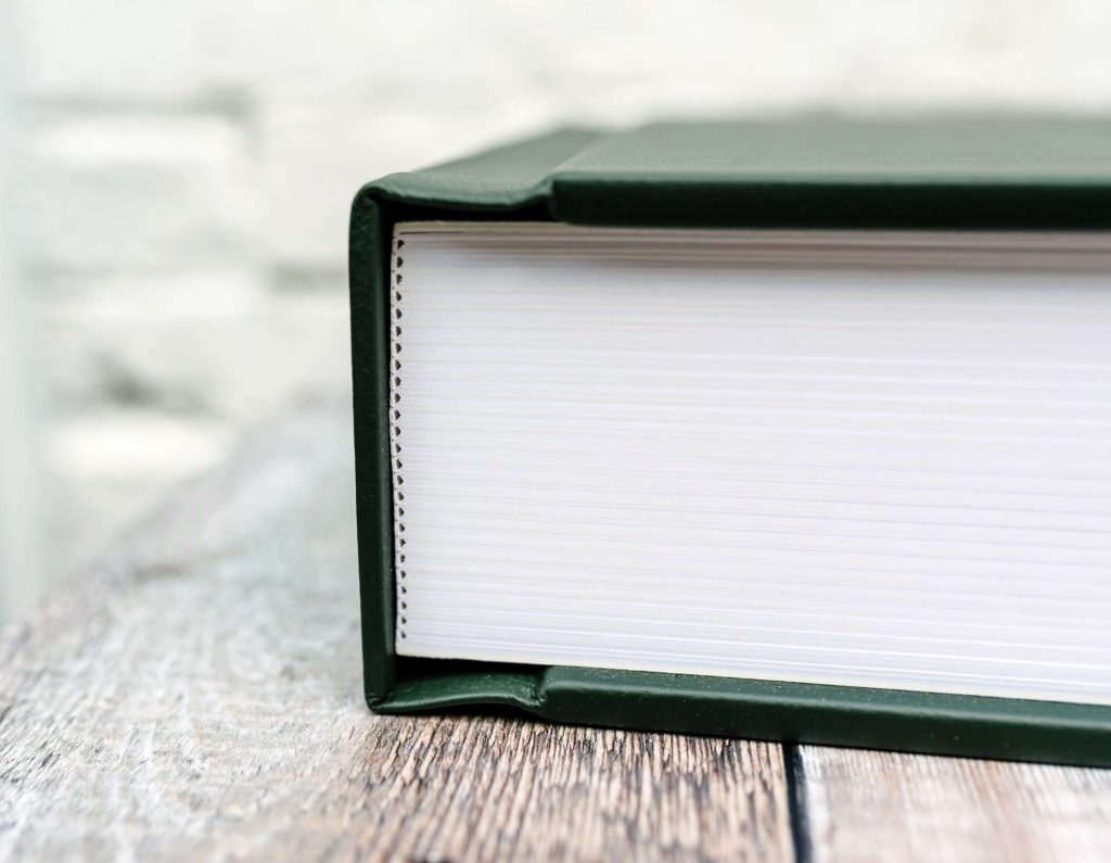 A detailed shot showing the handmade book spine of a luxury matted album for photos