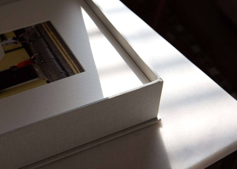 A detail shot of a handmade in the UK print box holding matted photographic prints