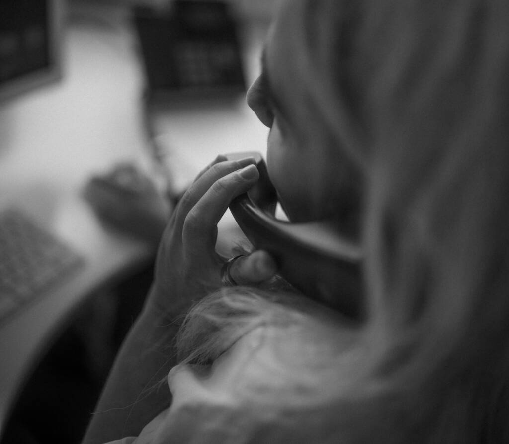 female on the phone in office in black and white 