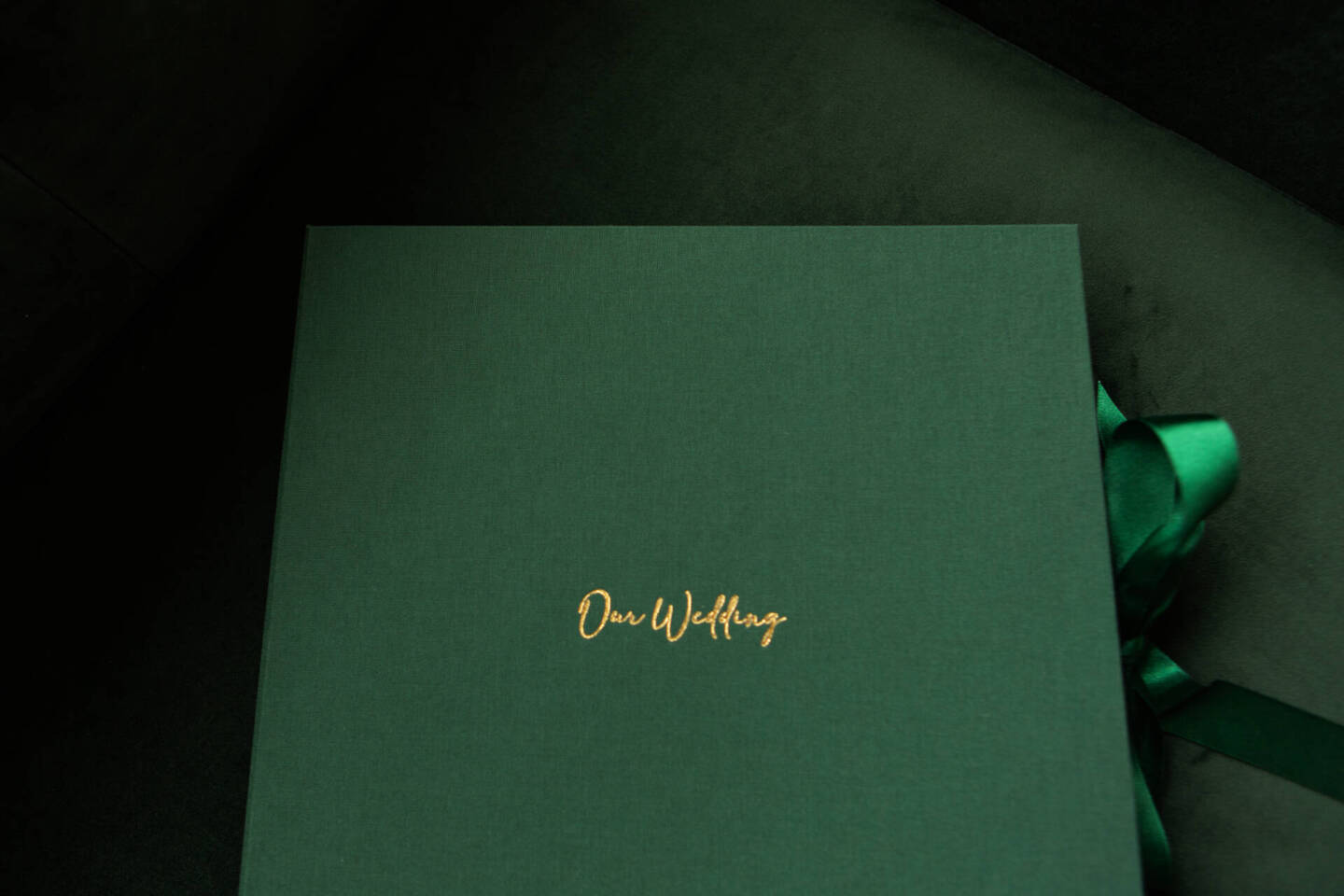 Dark green clamshell box with gold foiling writing for a winter wedding album