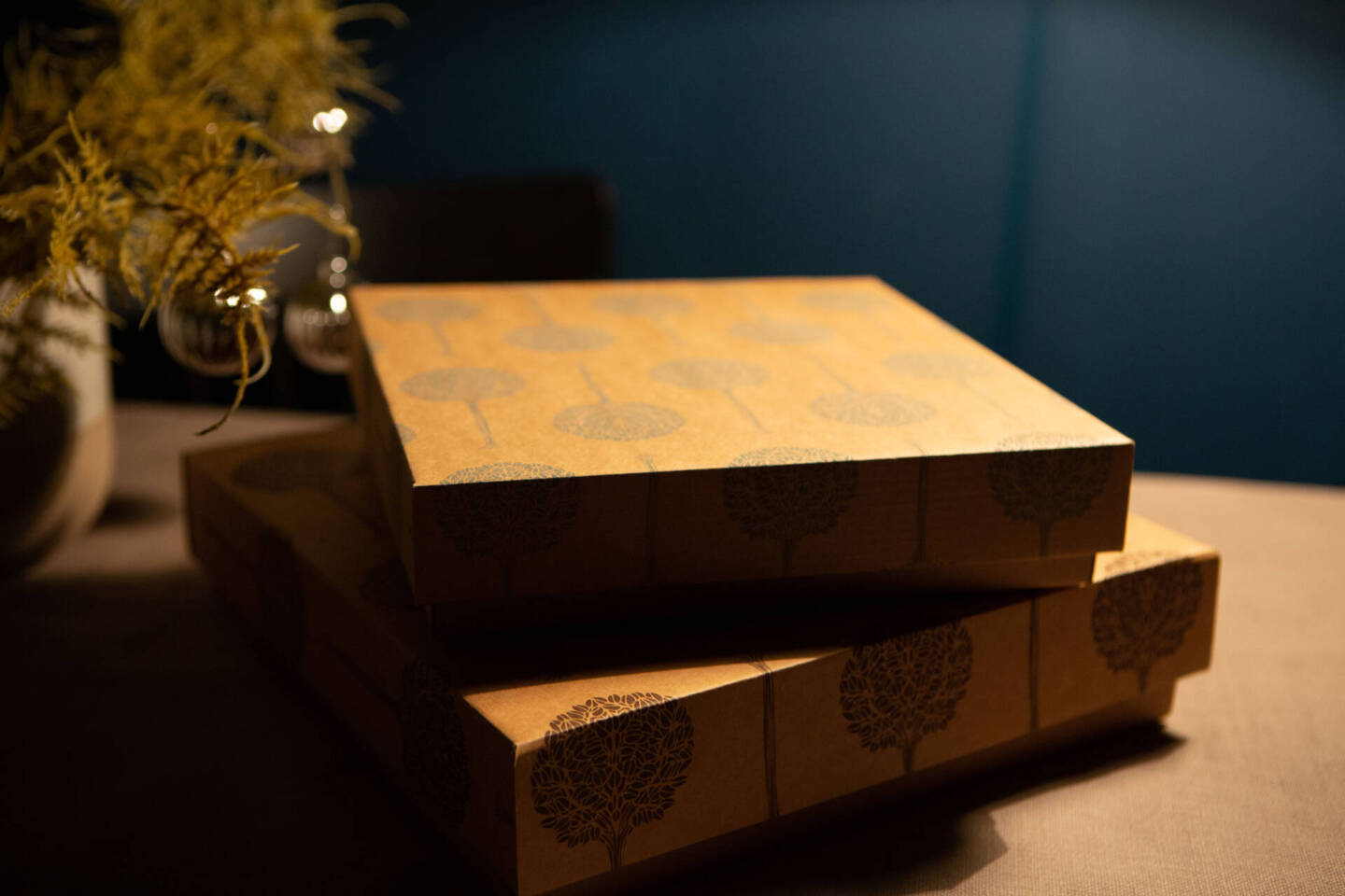 cardboard Folio boxes next to a Christmas tree with baubles