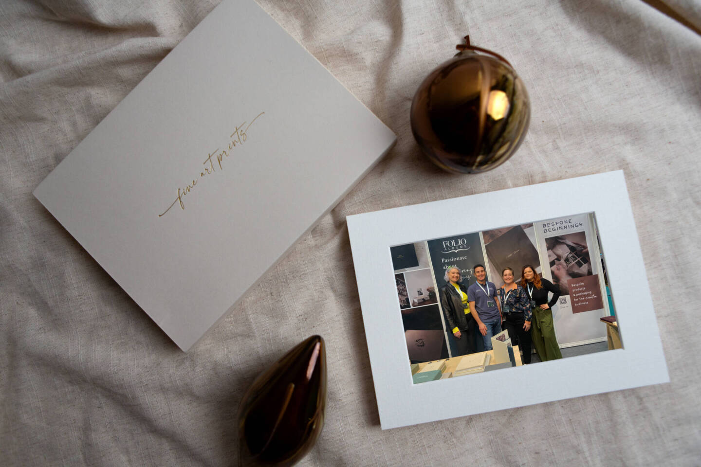 a print box on a blanket surrounded by baubles 