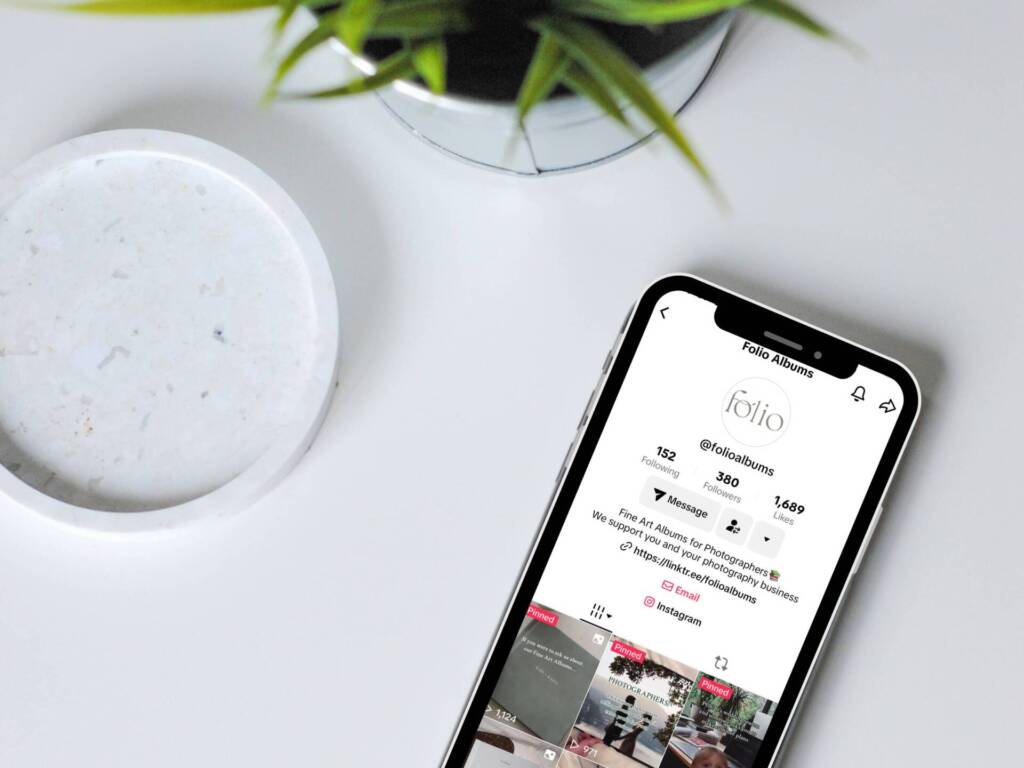 A photo of an iphone showing the Folio Albums TikTok account page