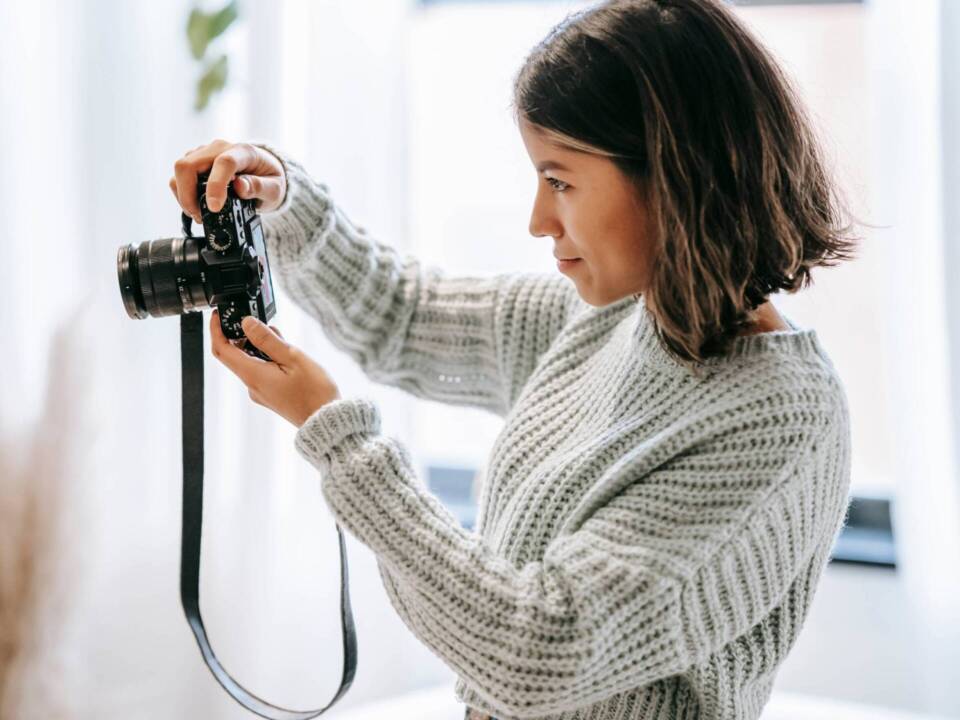 female wedding photographer holding up camera to take photo