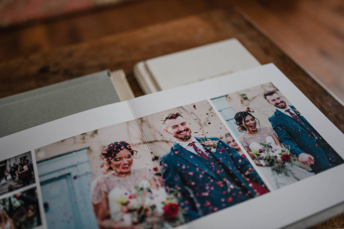 close up of wedding couple in wedding album on wooden table 