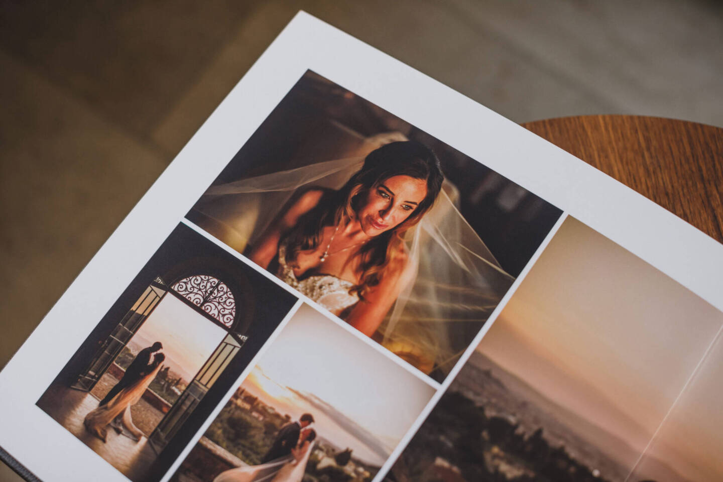 close up of a wedding album layout on a wooden table 