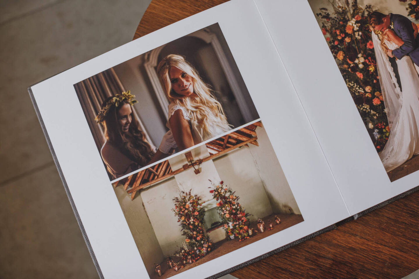 close up of wedding images in a fine art album on wooden table 