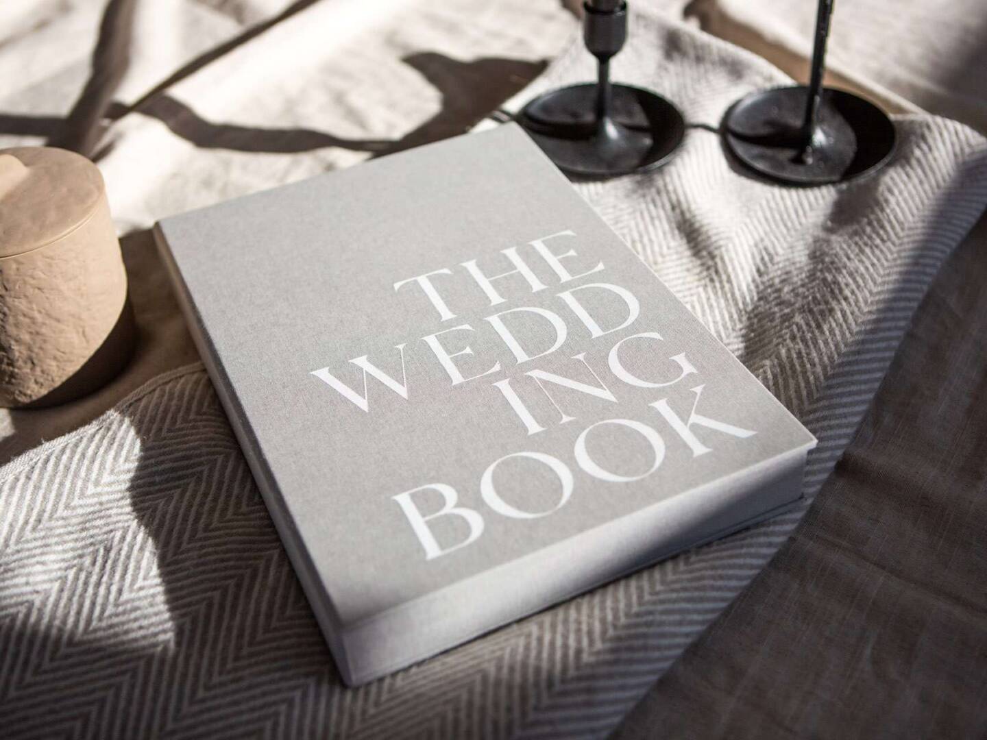 A Coffee Table Book with bold white 'The Wedding Book' text on the front cover.