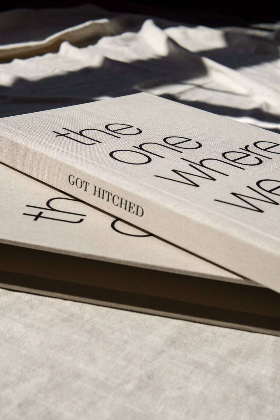 A closeup of spine personalisation text saying Got Hitched on a coffee table wedding album