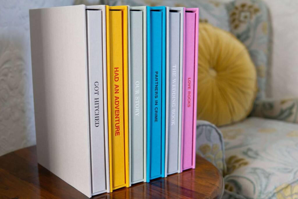 A row of high-quality coffee table photo books and slipcases in multiple colours with spine personalisation