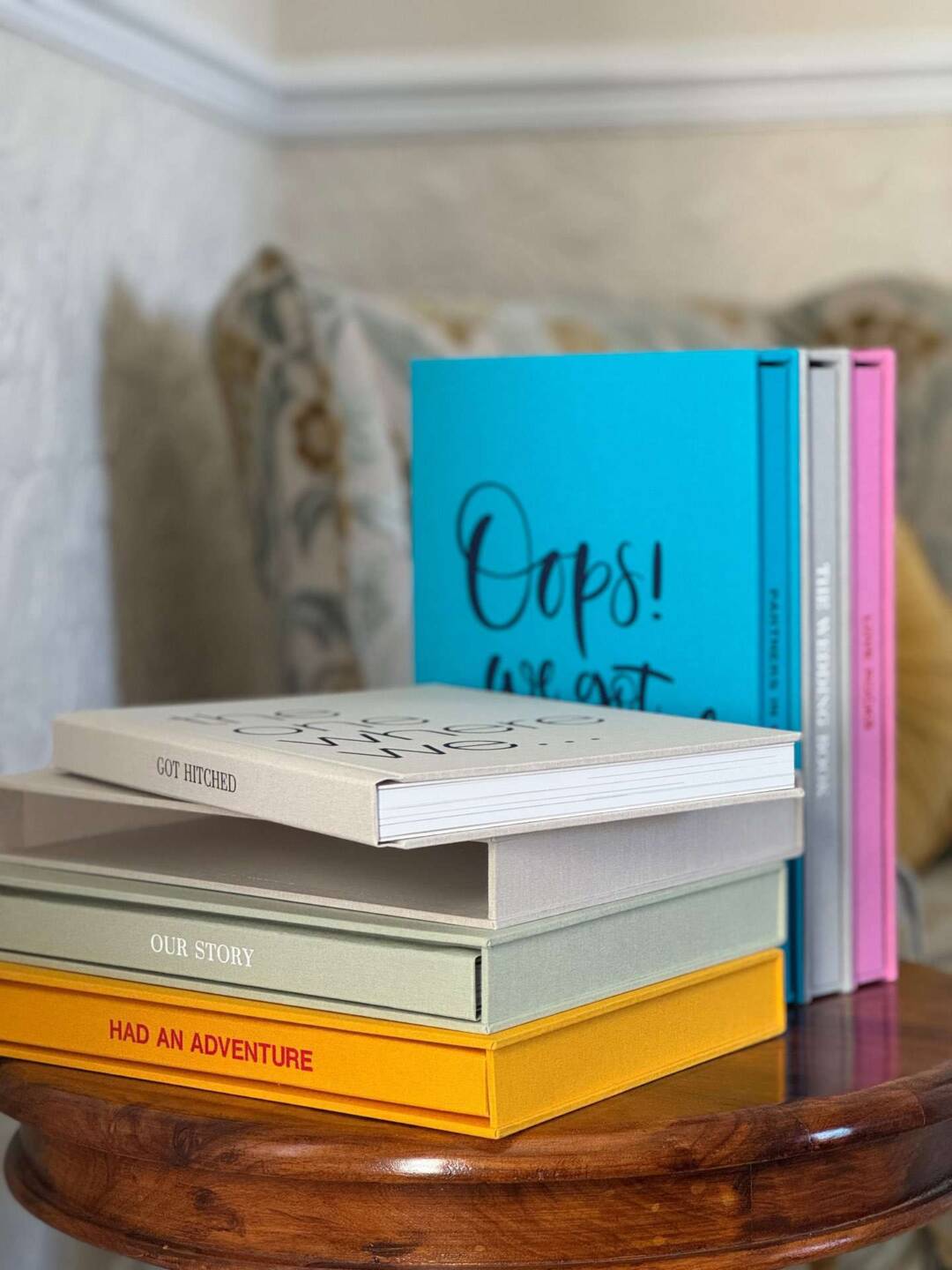 A collect of luxury coffee table photo books in orange, green, blue, pink, biscuit and gray