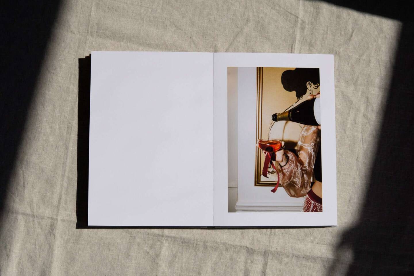 A layflat wedding magazine style A4 coffee table book open to show editorial style wedding photos