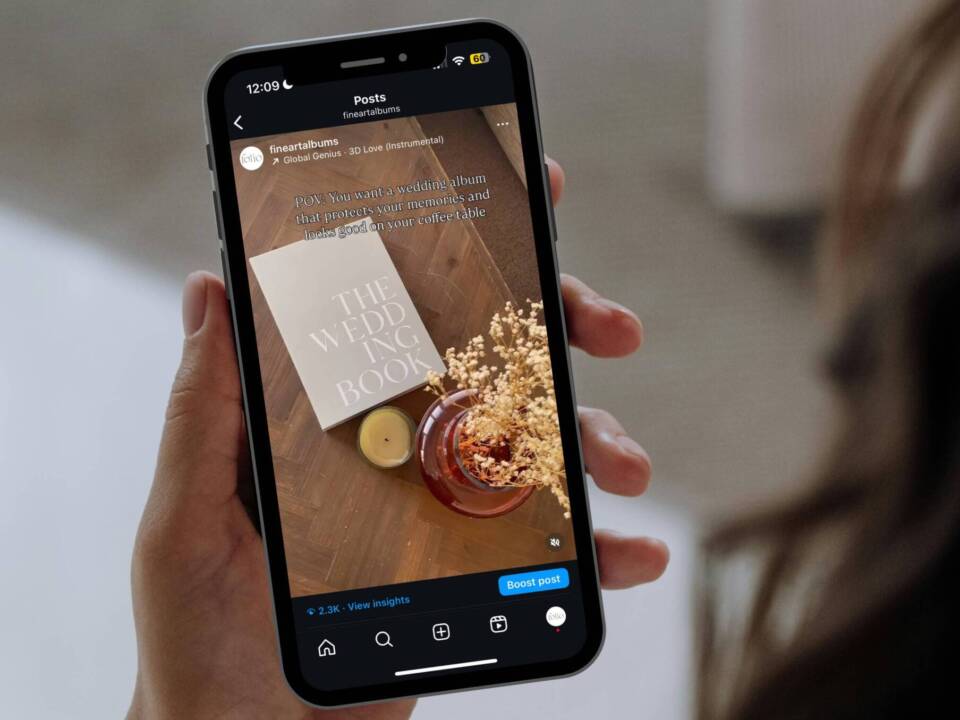 a woman holding an iPhone watching a Coffee Table Book Instagram reel